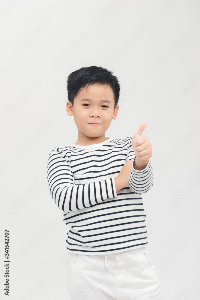 A portrait of a smiling boy holding his thumb up; isolated on the white background A portrait of a smiling boy holding his thumb up; isolated on the white background