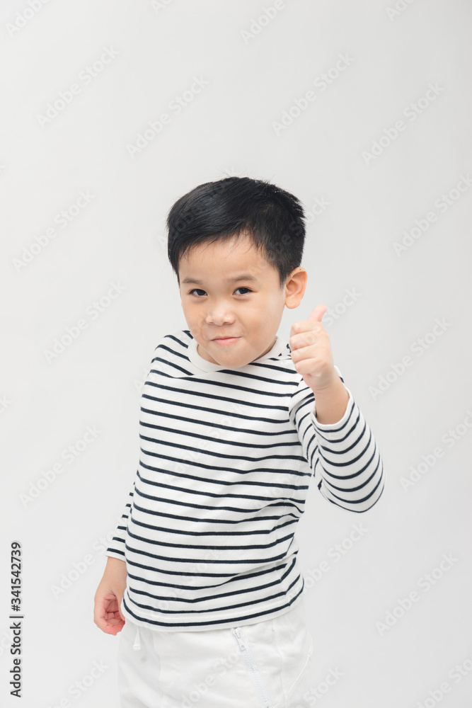 Kid giving thumbs up sign, smiling, isolated on white background Kid giving thumbs up sign, smiling, isolated on white background