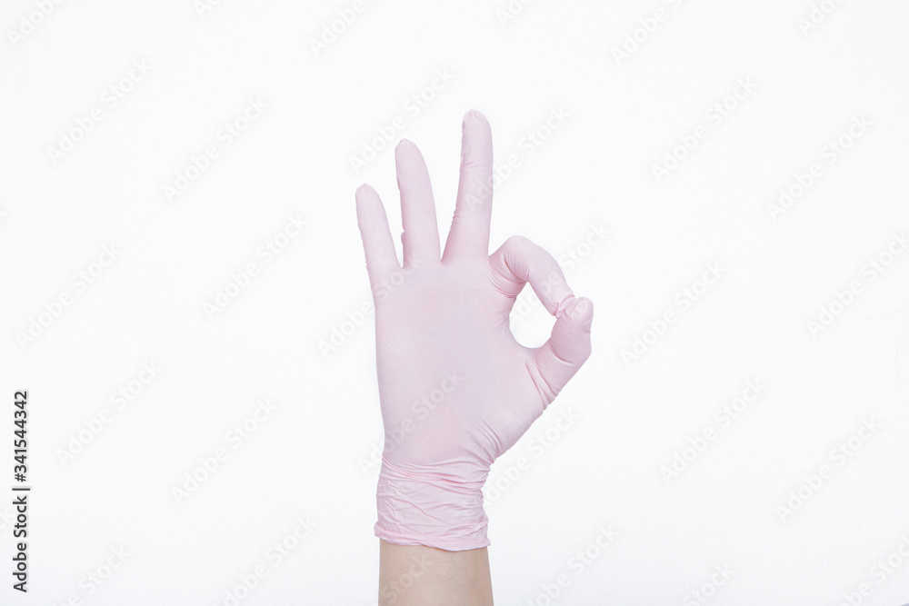 A large hand in a rubber glove close-up shows that everything will be fine. protective agent during an epidemic. Ads for antiseptics and medical equipment on a white background. A large hand in a rubber glove close-up shows that everything will be fine. protective agent during an epidemic. Ads for antiseptics and medical equipment on a white background.