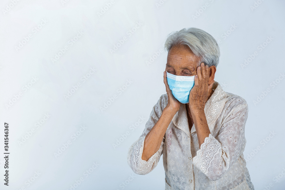Grandmother is feeling headache on white background.- concept mask campaign Grandmother is feeling headache on white background.- concept mask campaign