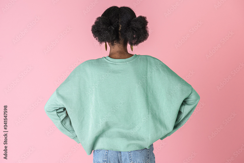 Black woman in a pastel sweater Black woman in a pastel sweater