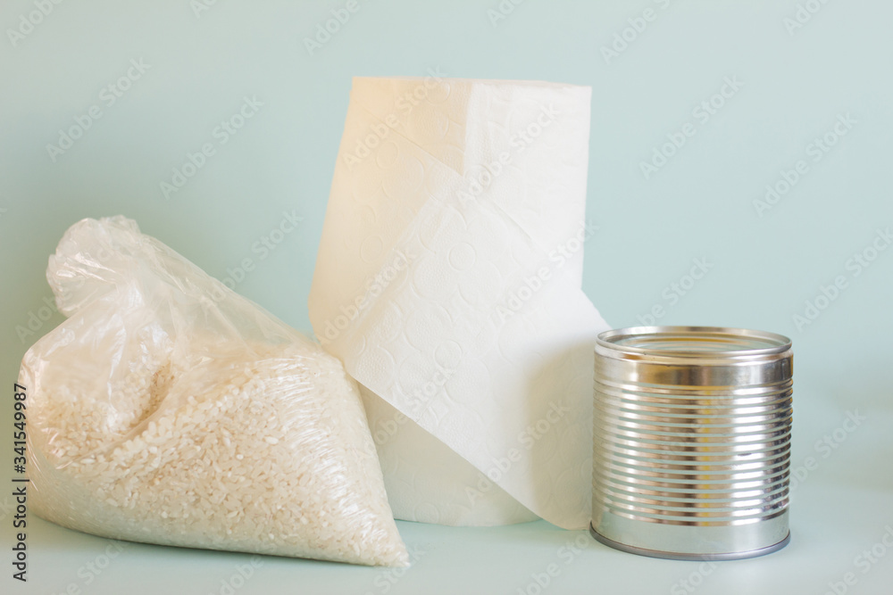 Donation food and charity concept. Pack of rice, toilet paper and canned food on blue background. Donation food and charity concept. Pack of rice, toilet paper and canned food on blue background.