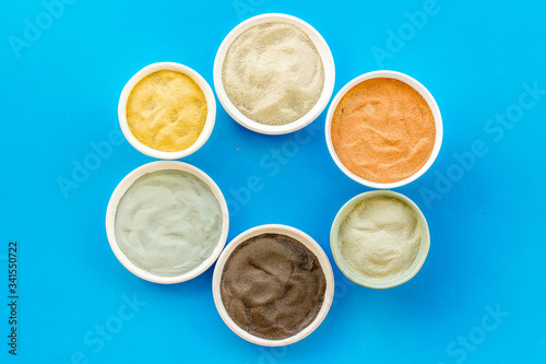 cosmetic clay - Yellow, red, white, blue and black dry powder - top-down flat lay