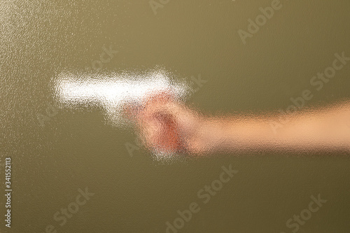 Hand holding a silver gun © rawpixel.com