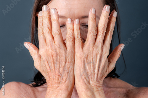 Close up of a senior woman with aging hands