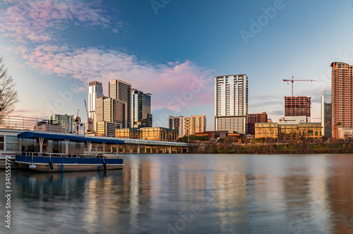 Downtown view across Lady Bird Lake or Town Lake on Colorado River at sunset golden hour in Austin, Texas, USA © SvetlanaSF