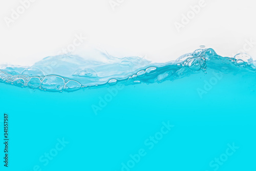 Blue water wave with splash and bubbles surface isolated on white .Abstract background.