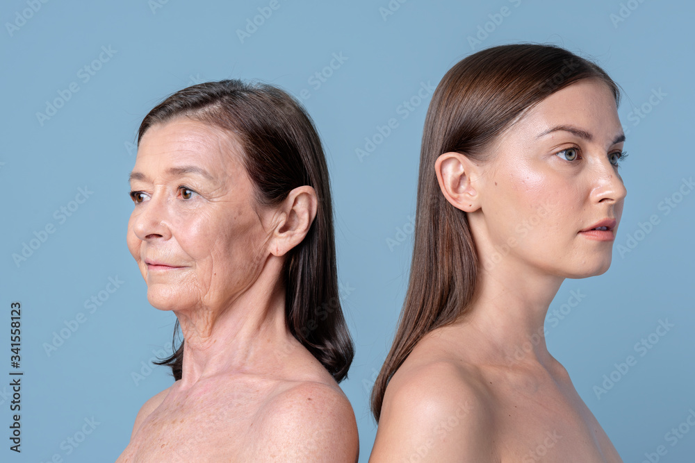 Two women standing back to back Two women standing back to back