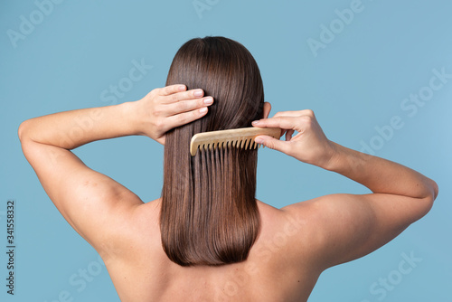 Woman combing her sleek hair