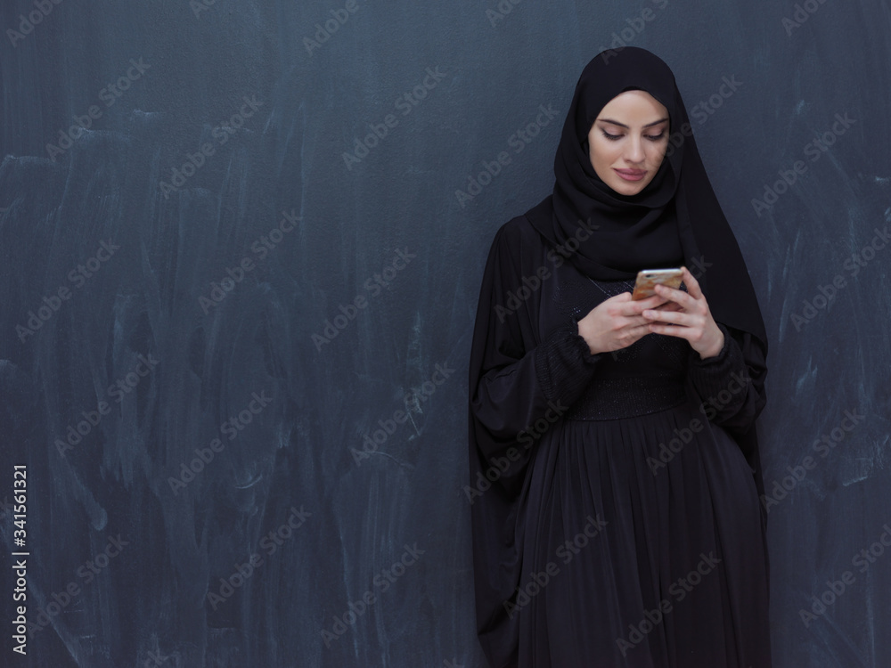 young modern muslim business woman using smartphone young modern muslim business woman using smartphone