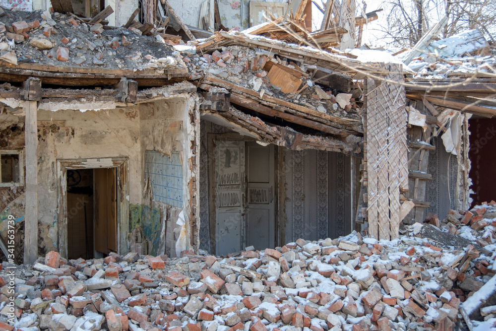 dismantling of old building, a building without a wall and roof with rickety second floor, a bunch of bricks and rubbish dismantling of old building, a building without a wall and roof with rickety second floor, a bunch of bricks and rubbish