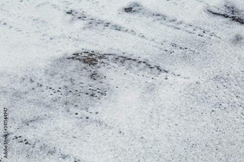 Sea foam in the sand on the shore. Close-up. Background. Space for text.