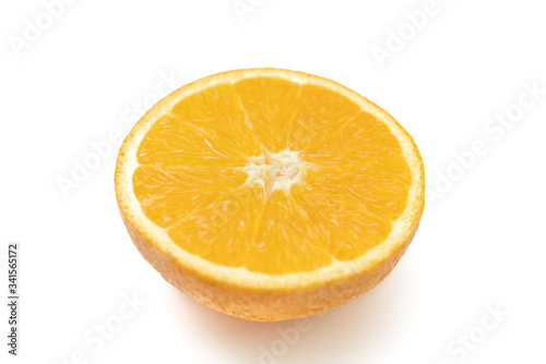 Side view close up of cut orange in white background isolated