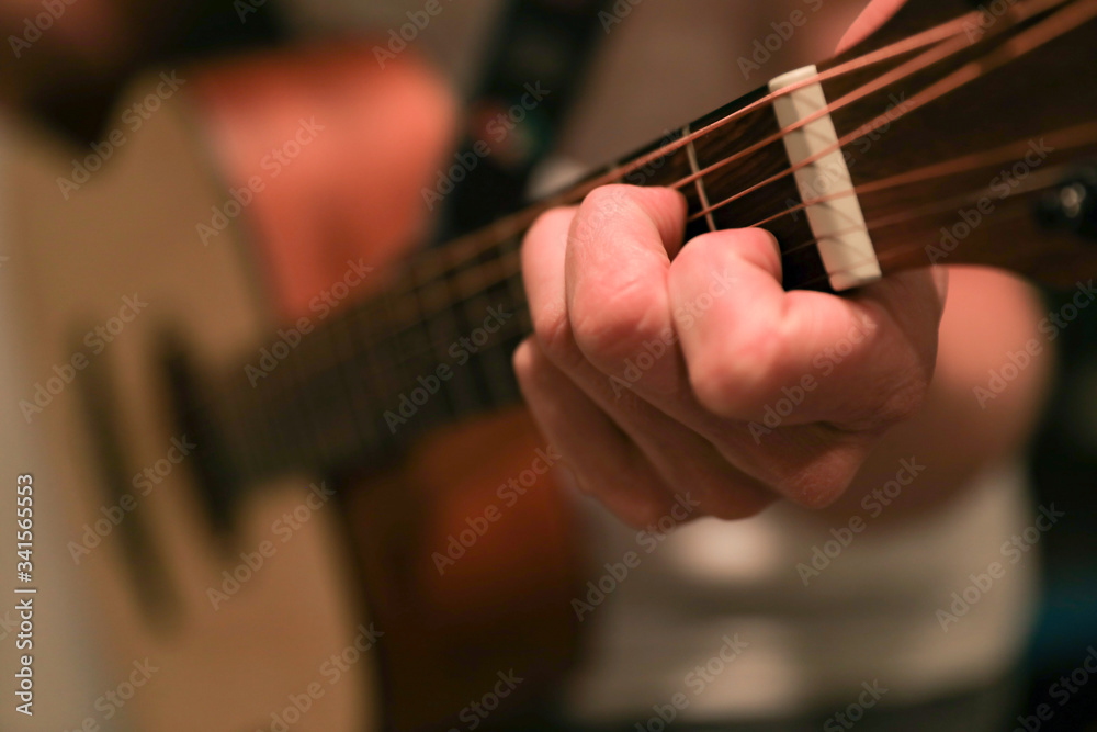 Closeup of hands playing a guitar