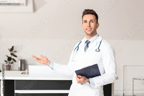 Male doctor near reception ...