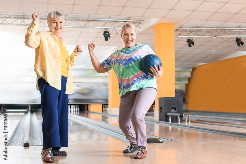Senior women playing bowling in club