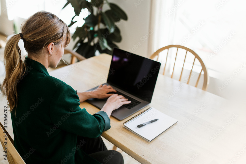 Woman working remotely from home during the coronavirus pandemic