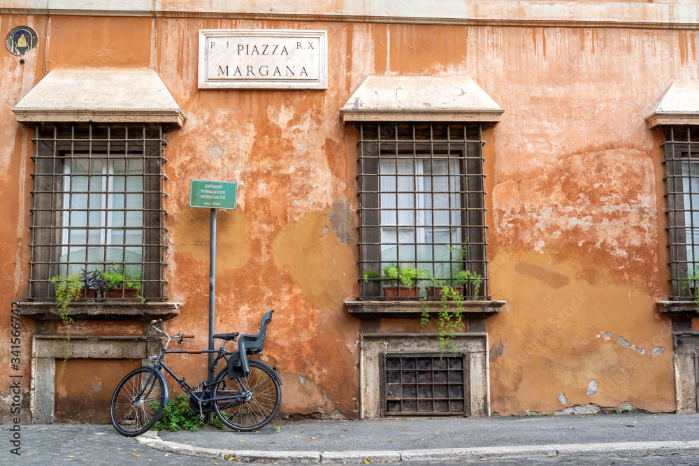 Rome, Italy - December 16, 2019: Bicycle on a old street in Rome, Italy. View of old cozy street in Rome.
