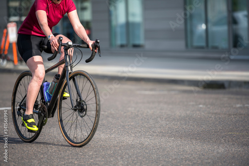 Woman in sportswear takes a bike ride preferring an active lifestyle that is healthy
