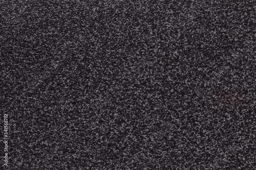 Grainy black background with gray spots. Texture backdrop with small crumb pattern for interior design.