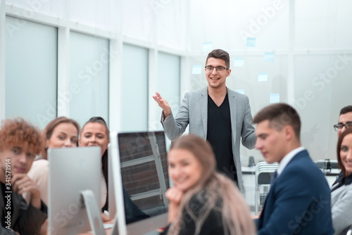 project Manager makes a report at an office meeting