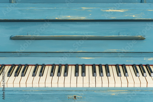 Keys of an old piano. Details of the design of the recolored blue and gold piano. Stucco on the piano photo