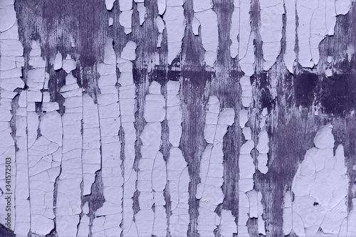 Abstract textured purple background. Old wooden surface with peeling paint. Texture of peeling paint on a wooden background. Close-up, cropped shot, free space, horizontal, toning.