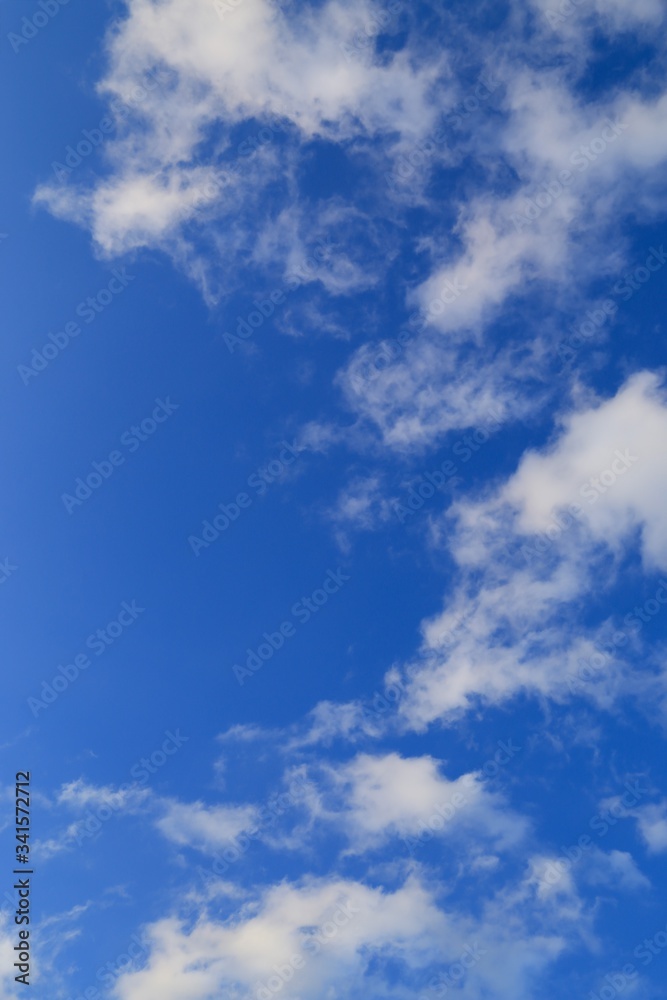 Fototapeta premium Vertical image of blue sky with white clouds