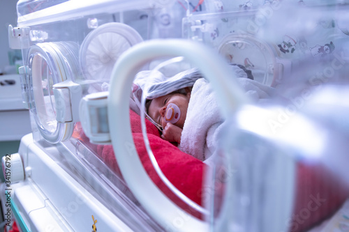 Newborn in incubator ICU