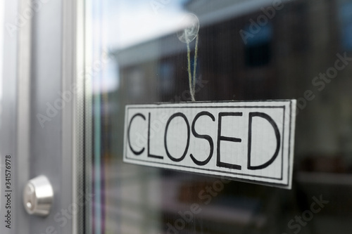 small business, pandemic and service concept - glass door of closed shop or office