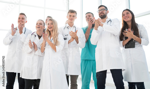 group of diverse medical staff members applauding together