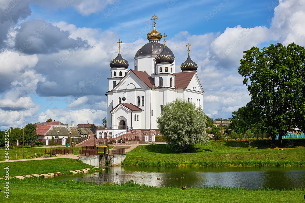 White stone Orthodox Church on the Bank of a pond in the city of Smorgon.