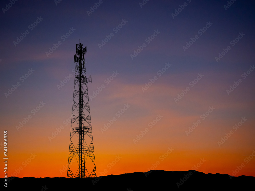Silhouette view of cellphone antenna under twilight sky