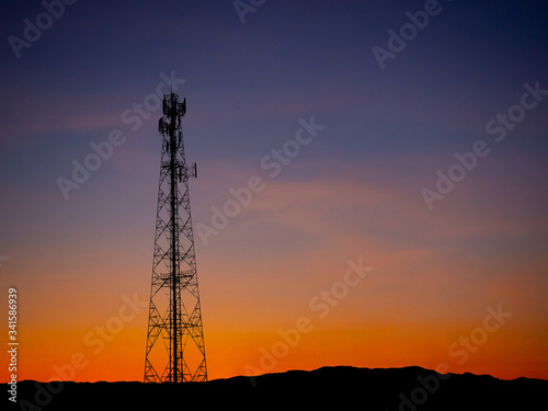 Silhouette view of cellphone antenna under twilight sky