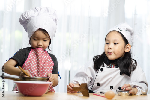 Happy Asian girsl playing chef at home. photo