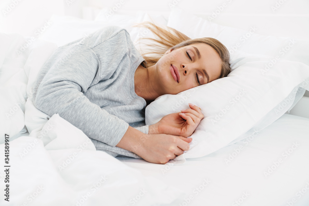Image closeup of cute young woman lying and sleeping in bed Image closeup of cute young woman lying and sleeping in bed