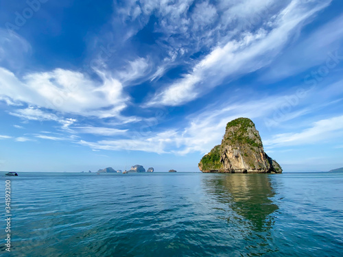 Great view from Pranang Beach on Railay Peninsula, Krabi Province in Thailand. Limestone islands in the sea, beautiful sunny sky with clouds, desktop background, landscape