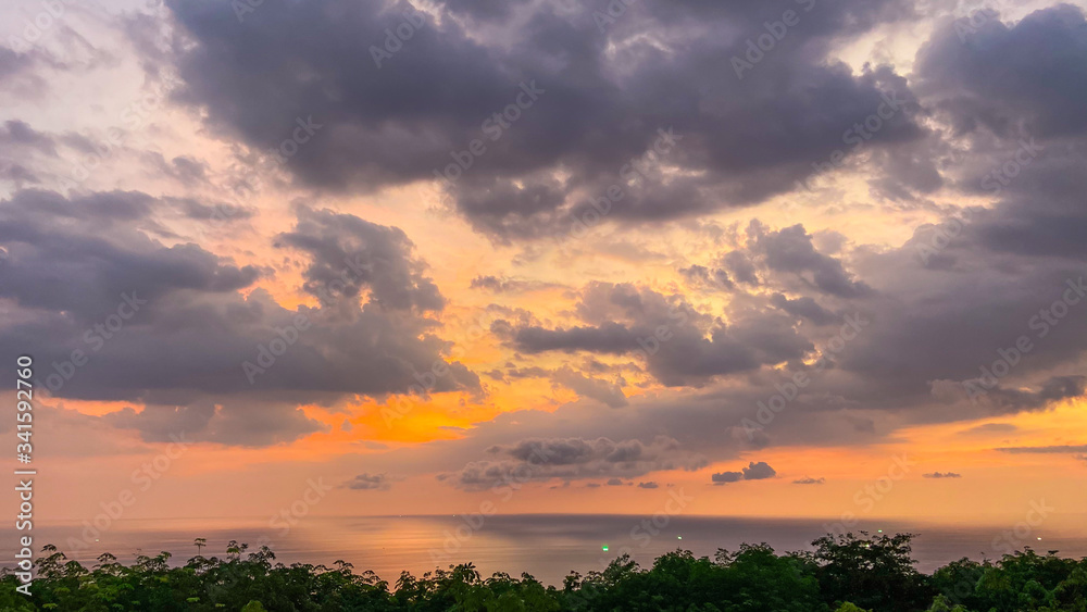 Beautiful sunset over the Andaman Sea, sun has already hidden behind the horizon, its last rays illuminate clouds, background for desktop, smart place for meditation