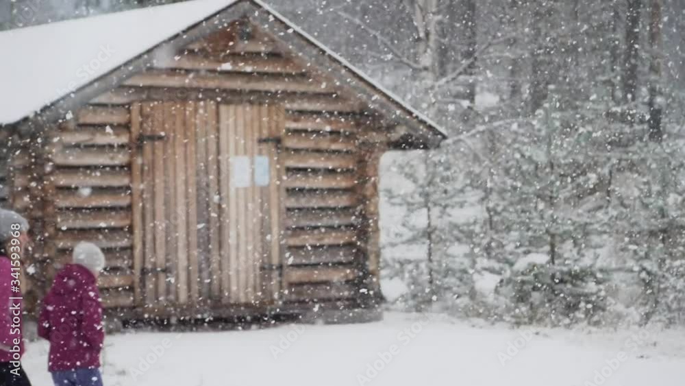 Young girl walking during snowfall in slowmotion Young girl walking during snowfall in slowmotion