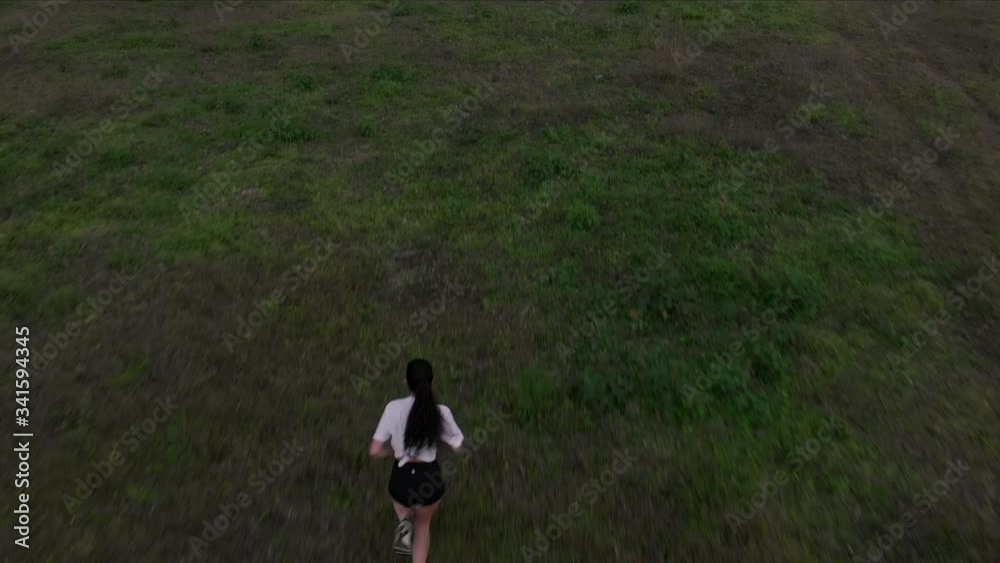 Arenal Volcano In Costa Rica - A Gorgeous Lady Running In A Vast Green Field Facing Towards The Majestic Volcano From Beyond - Aerial shot Arenal Volcano In Costa Rica - A Gorgeous Lady Running In A Vast Green Field Facing Towards The Majestic Volcano From Beyond - Aerial shot