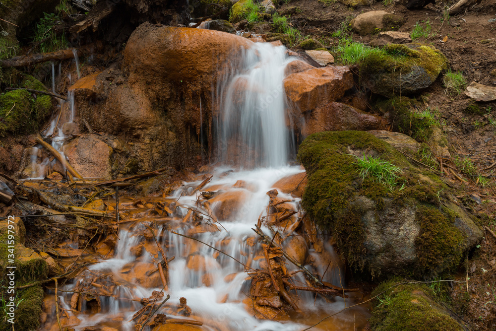 City Cesis, Latvia. Old waterfall with green moss and red rocks. City Cesis, Latvia. Old waterfall with green moss and red rocks.