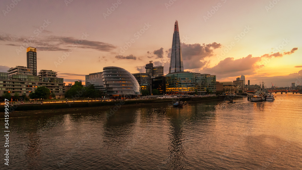 Panoramic view of the Shard and the HMS  Belfast ship from the Tower Bridge along the Thames river at sunset, London, England, GB