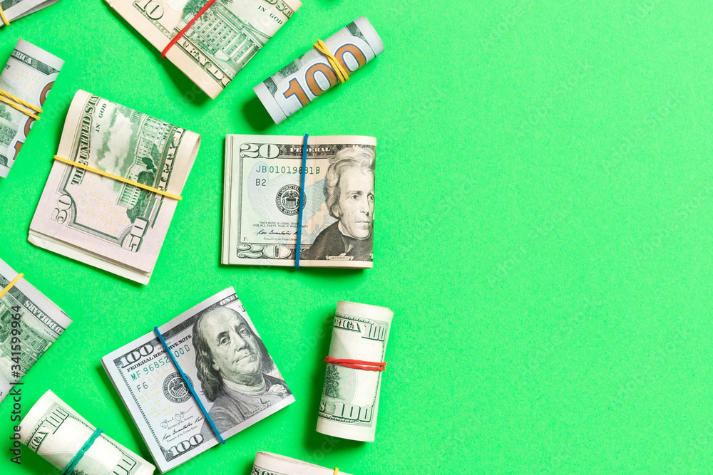 Pile of one hundred US Dollar Bills money on colored background top wiev with copy space for your text in financial concept