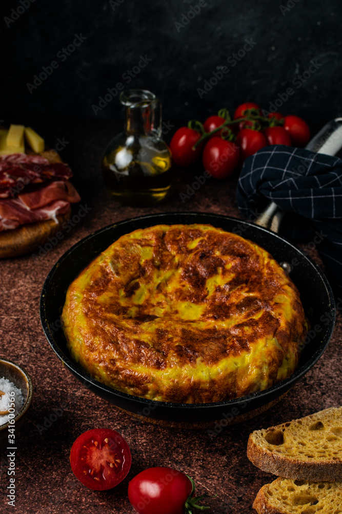 Traditional spanish tortilla omelette on dark rustic table