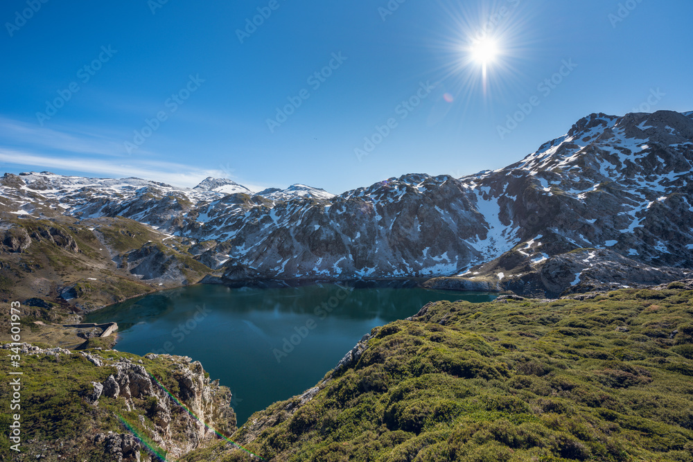 Calabazosa lake at the end of winter with snowy areas in the mountains. Saliencia lakes in the Somiedo Nature Park, Asturias, Spain.