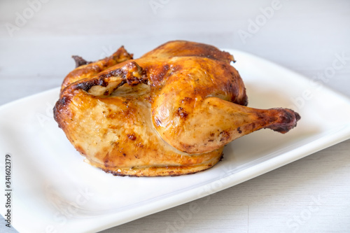 whole roasted chicken isolated on grey background