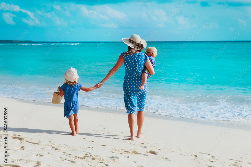 family on beach vacation-mother with two kids at sea family on beach vacation-mother with two kids at sea