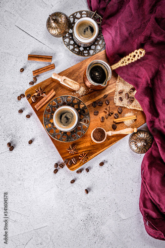 White coffee table with coffee beans, ground powder and spices. Arabic traditional styled coffee
