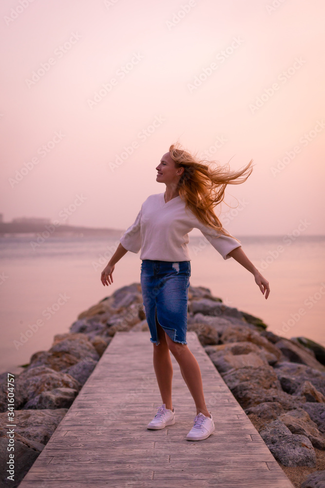 Blonde model on the beach at summer