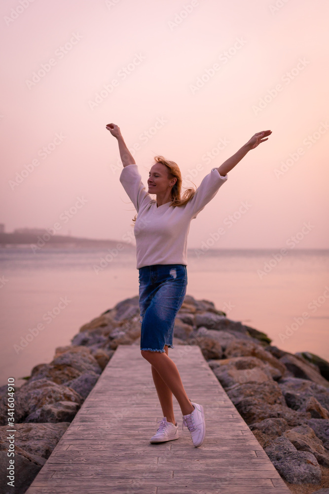Blonde model on the beach at summer